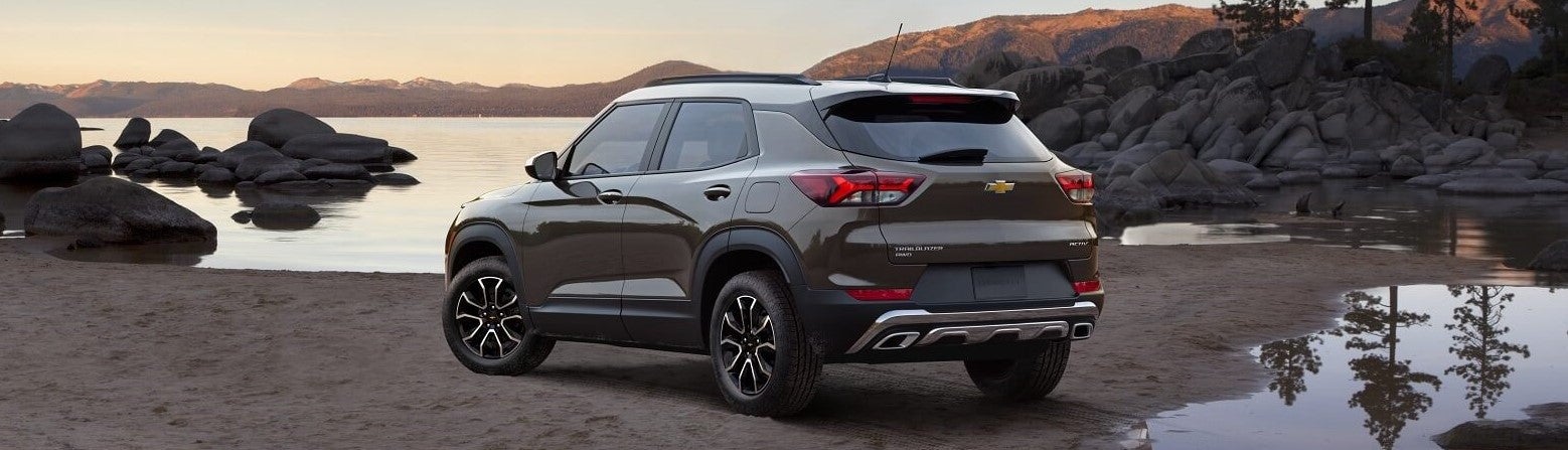 brown chevy crossover sitting on lake beach