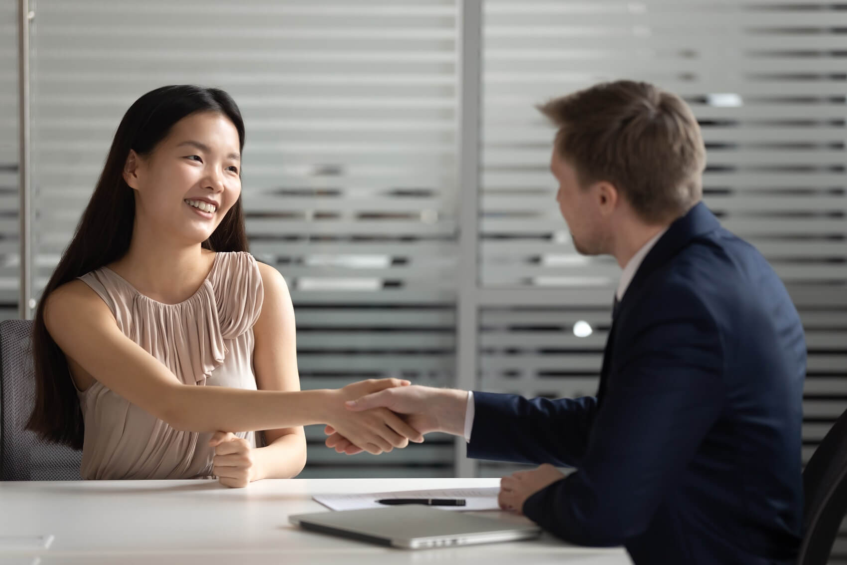 smiling customer shaking hands with finance officer at chevy finance center